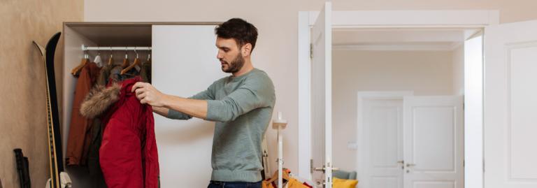 Passenger preparing luggage for a winter vacation. 