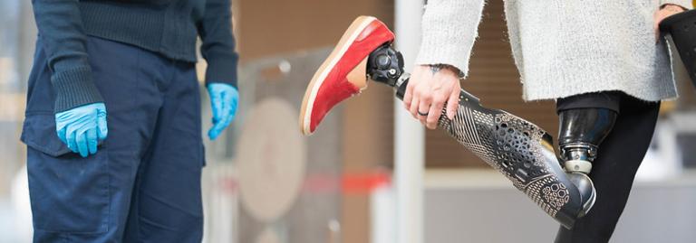 A passenger with a prosthetic leg is getting a physical search of person. 