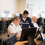 Two screening officers are having a discussion in remote screening.